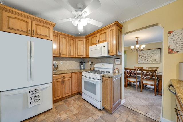 kitchen featuring pendant lighting, white appliances, crown molding, decorative backsplash, and ceiling fan with notable chandelier