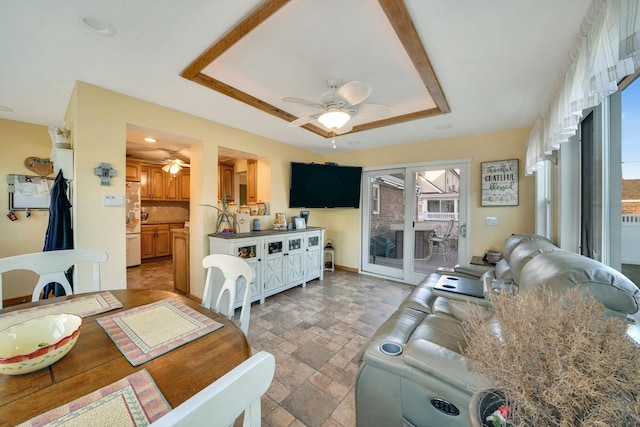 dining room featuring a tray ceiling and ceiling fan