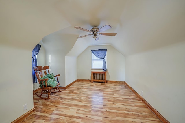 additional living space featuring vaulted ceiling, light hardwood / wood-style floors, and ceiling fan