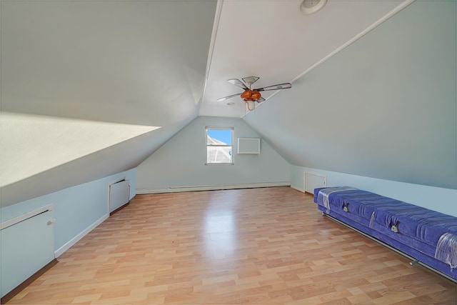 additional living space featuring vaulted ceiling, ceiling fan, and light wood-type flooring