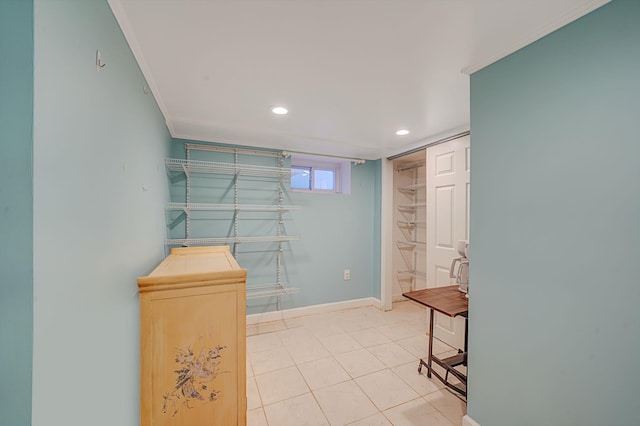 interior space with crown molding and light tile patterned floors