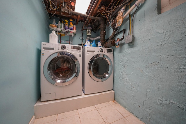 laundry room with independent washer and dryer and tile patterned floors