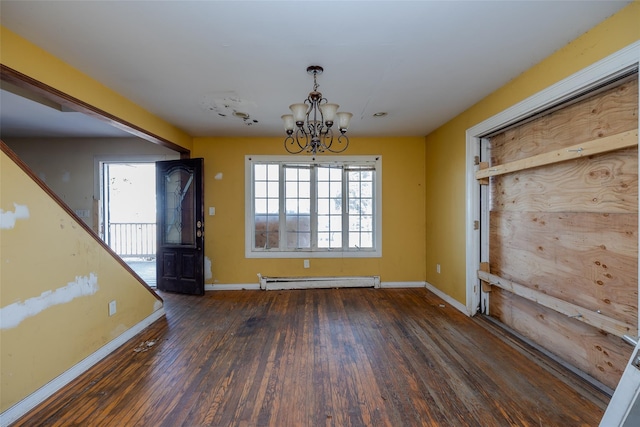 unfurnished dining area with dark hardwood / wood-style flooring, a baseboard heating unit, and an inviting chandelier