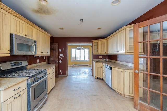 kitchen with sink, appliances with stainless steel finishes, a notable chandelier, a baseboard radiator, and light brown cabinets