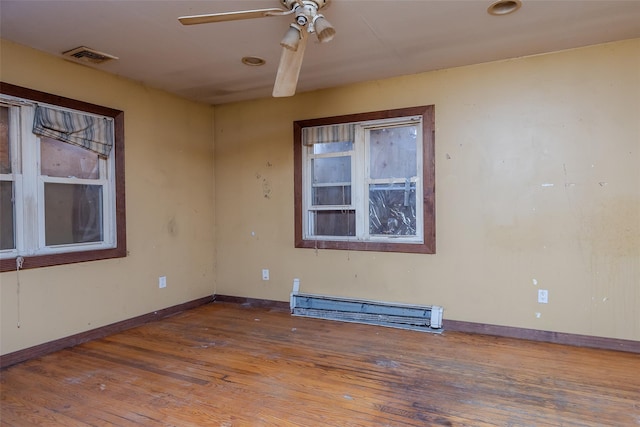 spare room featuring ceiling fan, a baseboard radiator, and wood-type flooring