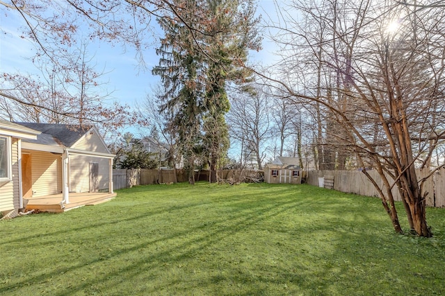 view of yard featuring an outbuilding and a wooden deck