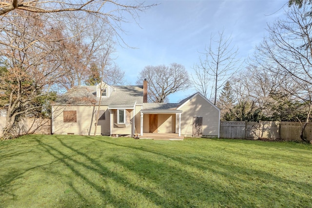 rear view of property featuring a yard