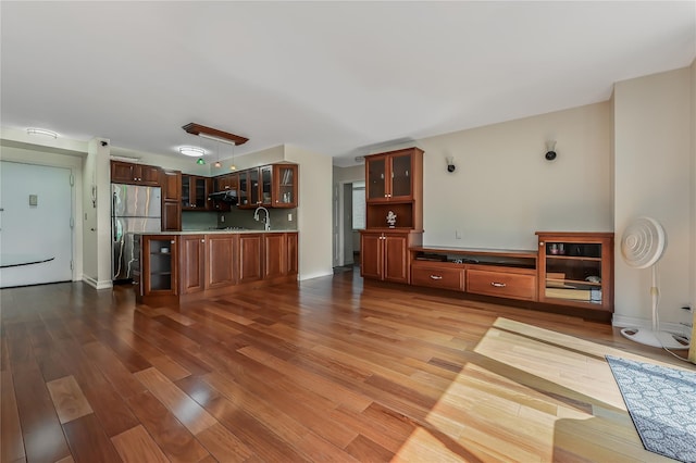 living room featuring wood-type flooring and sink