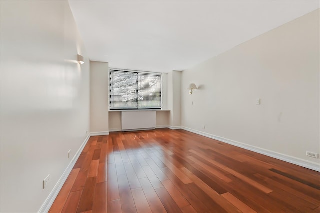 empty room with hardwood / wood-style flooring