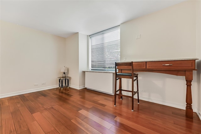 unfurnished office featuring dark wood-type flooring