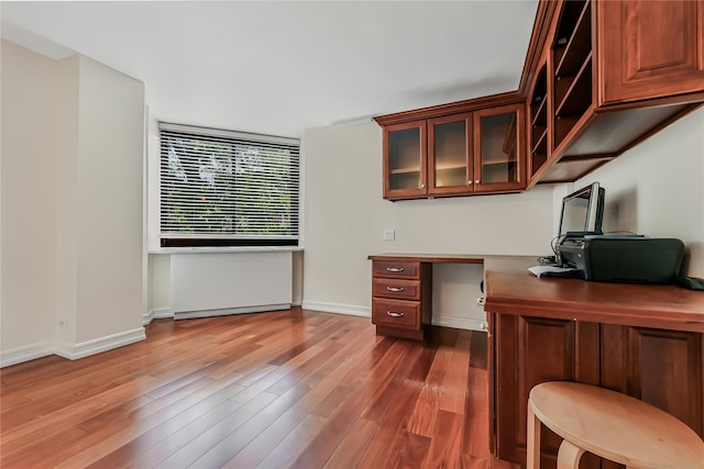 office area with built in desk and dark hardwood / wood-style flooring