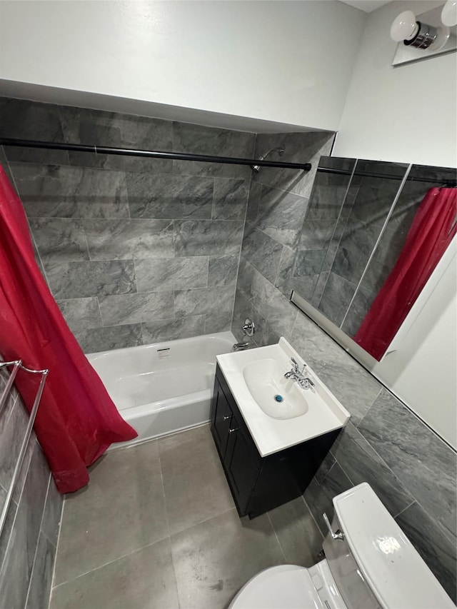 full bathroom with tile walls, vanity, toilet, shower / bathtub combination with curtain, and tile patterned floors