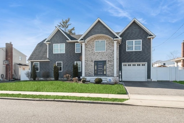 view of front of property with a garage and a front lawn