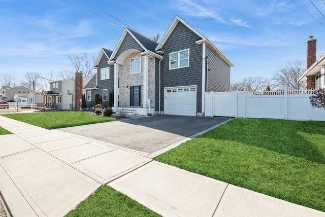 front of property featuring a garage and a front yard