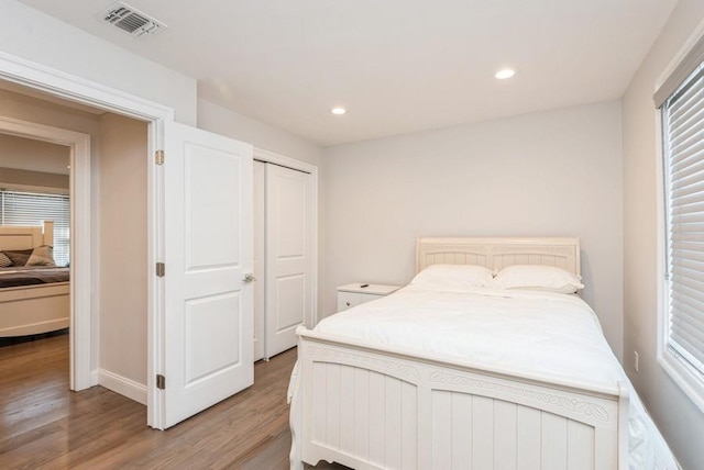 bedroom featuring a closet and light wood-type flooring