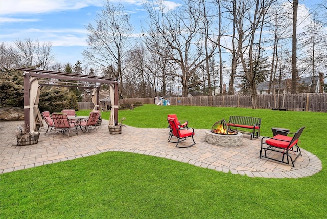 view of yard with an outdoor fire pit, a patio area, a fenced backyard, and a pergola