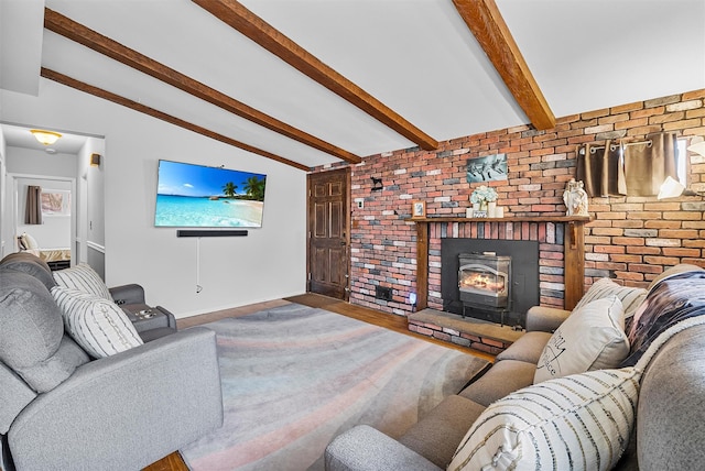 living area featuring baseboards, lofted ceiling with beams, brick wall, and wood finished floors