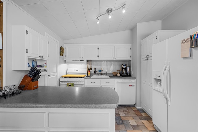 kitchen featuring under cabinet range hood, a peninsula, white appliances, a sink, and white cabinetry