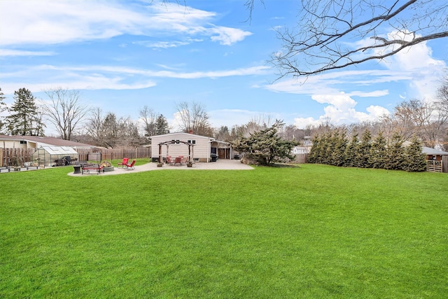 view of yard featuring fence, a fire pit, and a patio