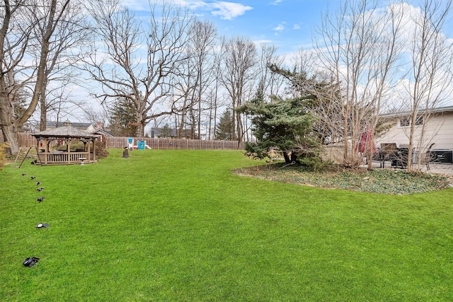 view of yard with fence and a gazebo