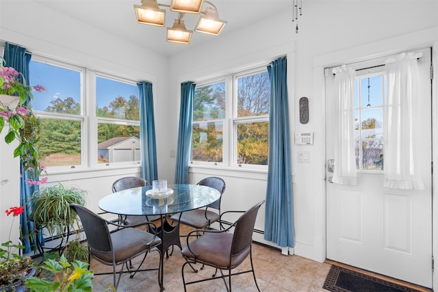 dining area featuring plenty of natural light and a baseboard radiator