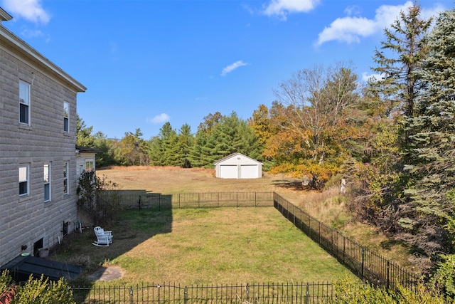 view of yard featuring a garage and an outdoor structure