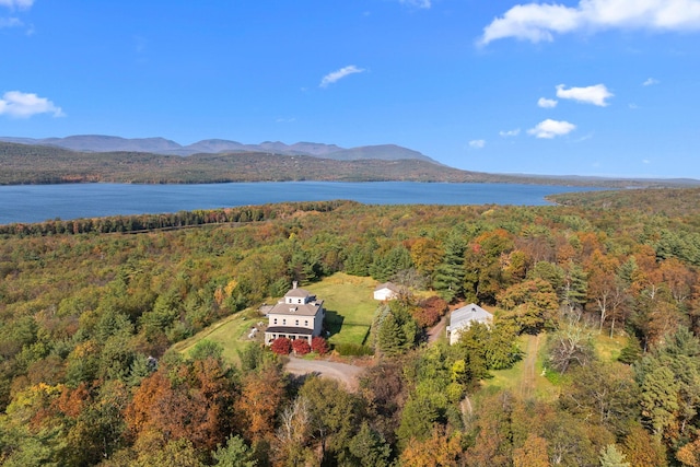 aerial view with a wooded view and a water and mountain view