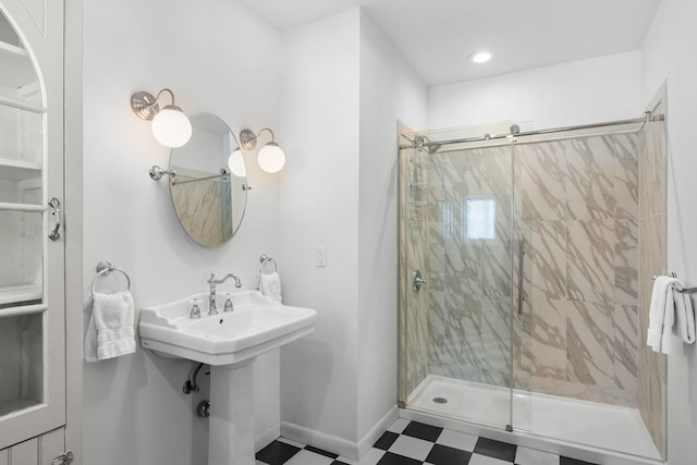 bathroom with baseboards, tile patterned floors, a shower stall, a sink, and recessed lighting