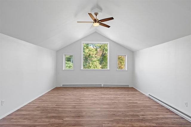 additional living space featuring ceiling fan, lofted ceiling, a baseboard radiator, a baseboard heating unit, and light wood-style floors