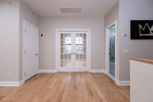 interior space with french doors and light wood-type flooring