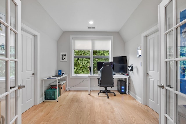 office area with lofted ceiling, light hardwood / wood-style floors, and french doors