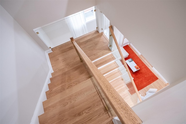 staircase with wood-type flooring