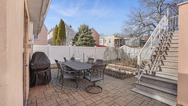 view of patio / terrace with a fenced backyard, a grill, and outdoor dining area