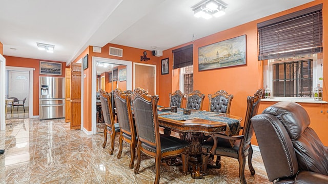 dining room with marble finish floor, visible vents, and baseboards