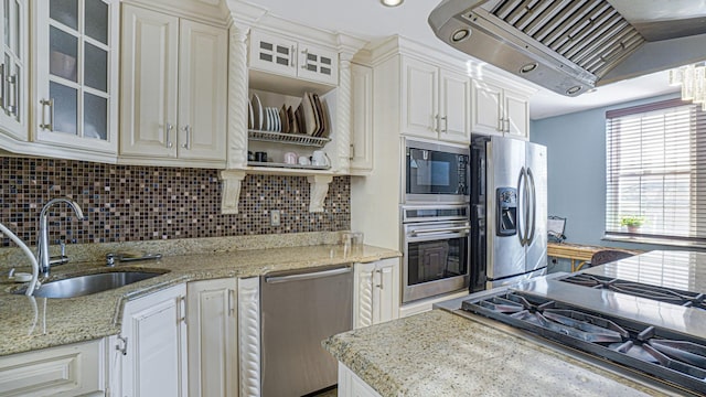 kitchen featuring premium range hood, glass insert cabinets, stainless steel appliances, and a sink