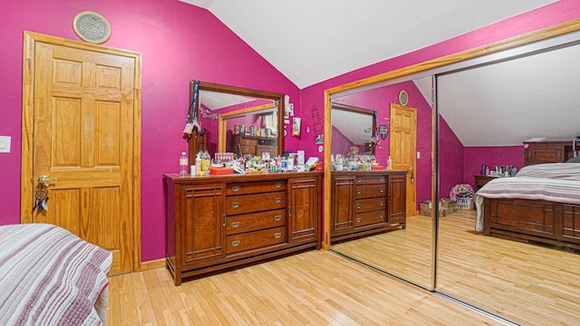 bedroom featuring vaulted ceiling and light wood finished floors