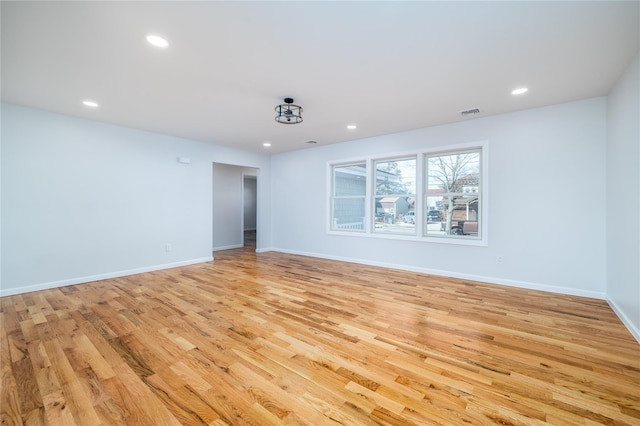 spare room featuring light hardwood / wood-style floors