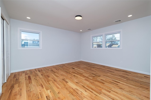 spare room featuring light wood-type flooring