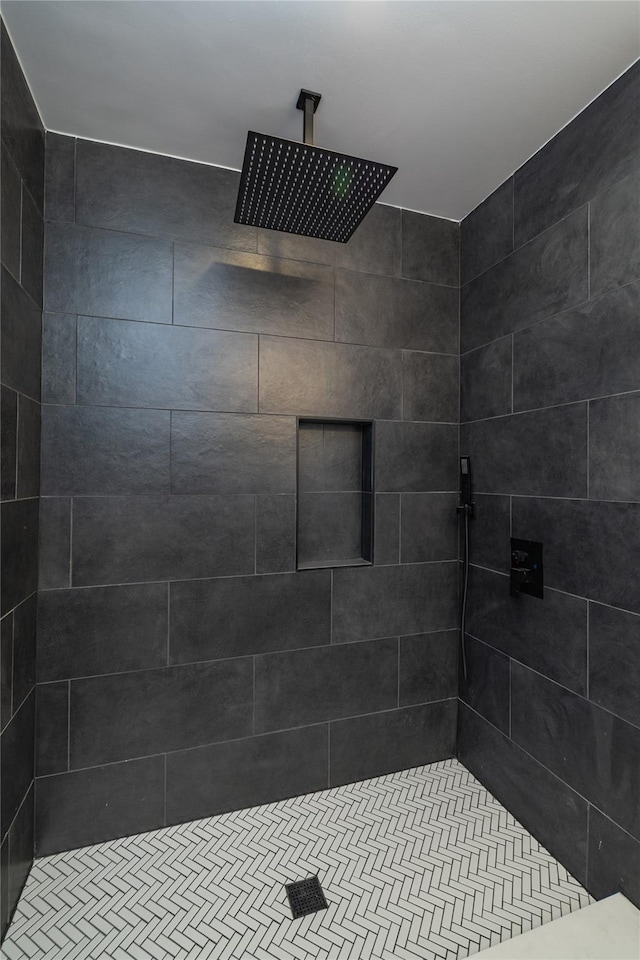 bathroom with tiled shower