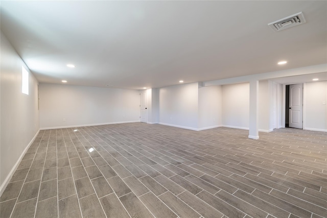 basement with hardwood / wood-style floors