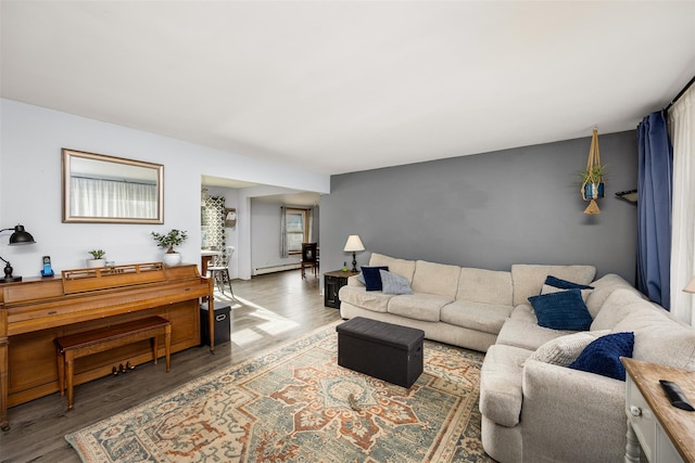 living room with a baseboard heating unit and wood-type flooring