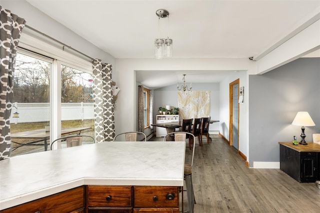 kitchen featuring a chandelier, pendant lighting, and light hardwood / wood-style floors