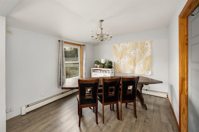 dining space with dark wood-type flooring, a chandelier, and a baseboard heating unit