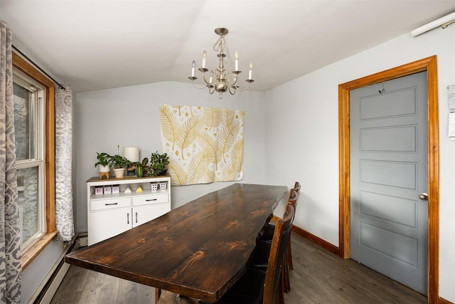 dining space featuring dark hardwood / wood-style floors, vaulted ceiling, and a notable chandelier