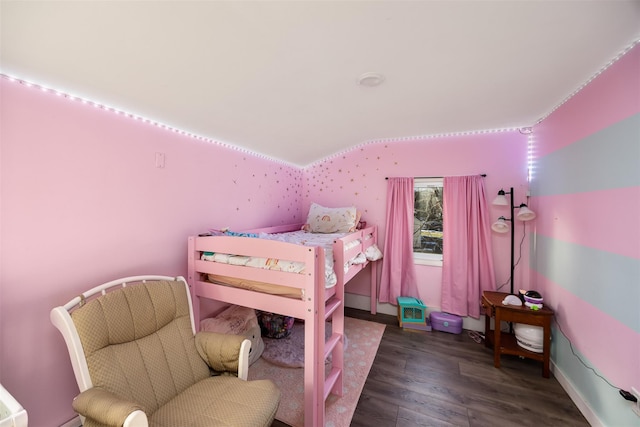 bedroom with dark hardwood / wood-style floors