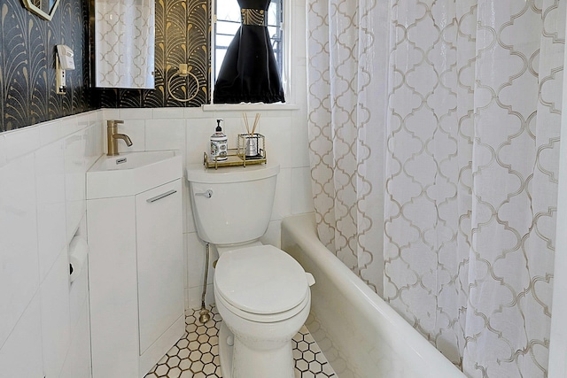 bathroom featuring wallpapered walls, vanity, toilet, and tile walls