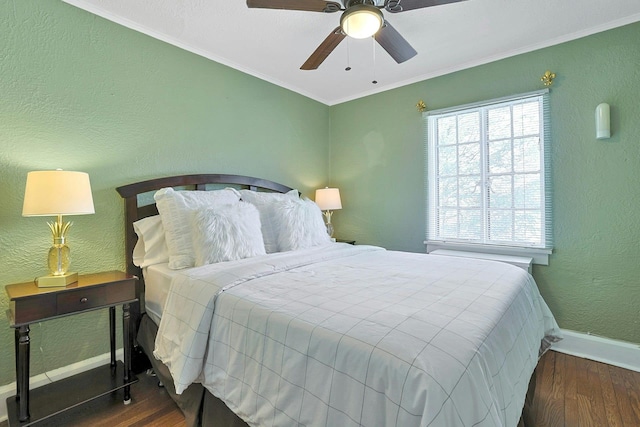 bedroom with ornamental molding, wood finished floors, and baseboards