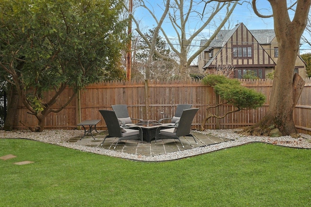 view of yard with a fire pit, a patio area, and fence