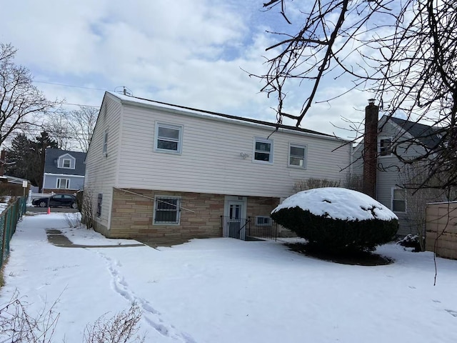 view of snow covered back of property