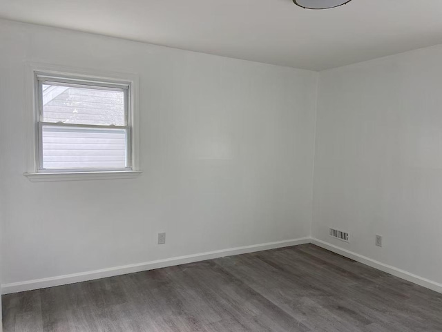 spare room featuring dark hardwood / wood-style floors